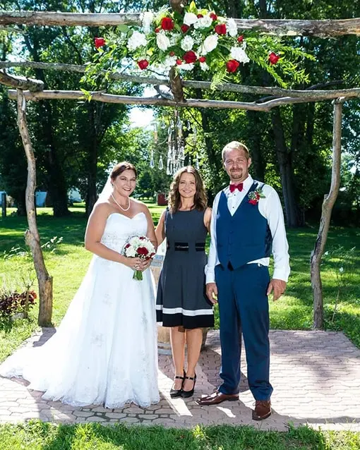 Photo of Grooms shoes, a watch, and a wedding book and rings are the center of the photo