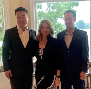 Wedding officiant Indianapolis LGBTQ in black and white suite next to two men in black suites with white shirts