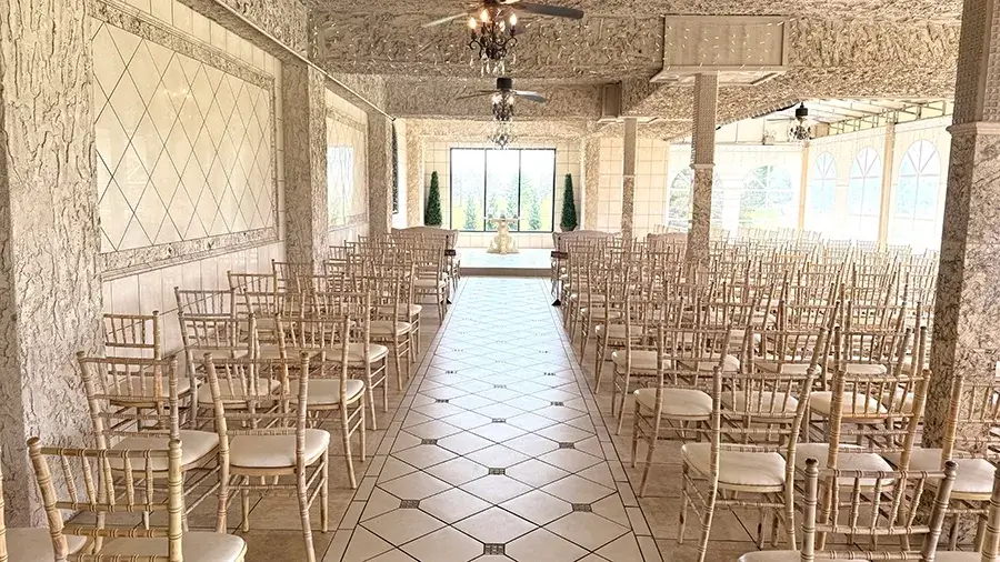 Ceremony chairs set in a bright hall with a checkered floor