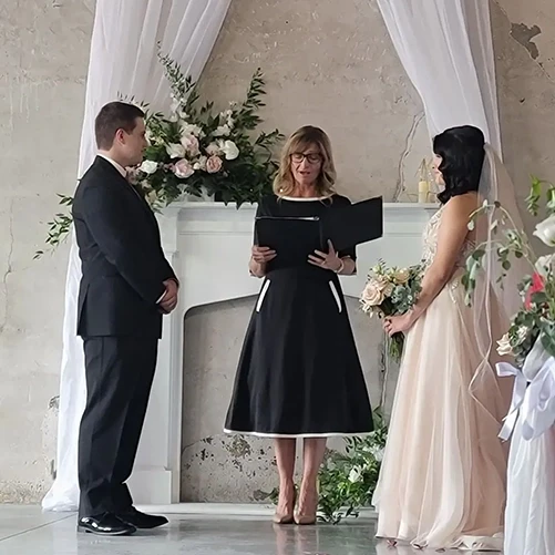 Wedding officiant leading intimate ceremony at Ivory Foundry Indianapolis Indiana — wedding coordination by Weddings by Bretta