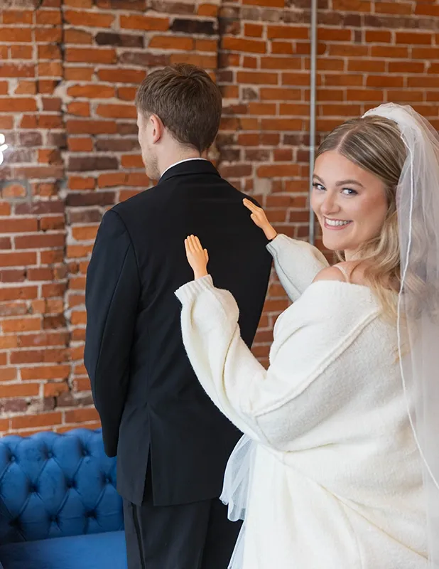 Bride First Look Moment at Ivory Foundry Indianapolis Indiana — Wedding Coordination by Weddings by Bretta Bride in white gown and veil smiling during first look moment against exposed brick wall at Ivory Foundry Indianapolis Indiana — wedding coordination by Weddings by Bretta