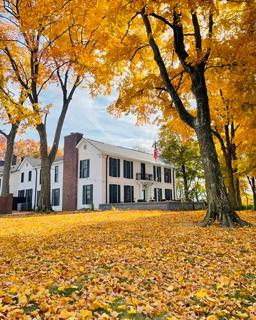 Folktale Venue in Greenwood Indiana surrounded by golden fall foliage — wedding coordination by Weddings by Bretta