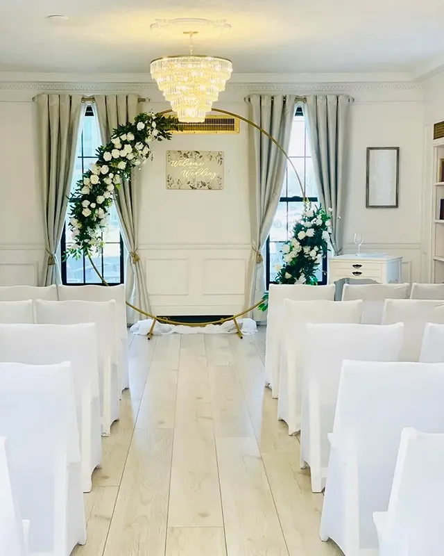 Indoor Ceremony Setup at Folktale Venue Greenwood Indiana — Wedding Coordination by Weddings by Bretta Indoor wedding ceremony setup with gold circular arch and white floral arrangements at Folktale Venue Greenwood Indiana — wedding coordination by Weddings by Bretta