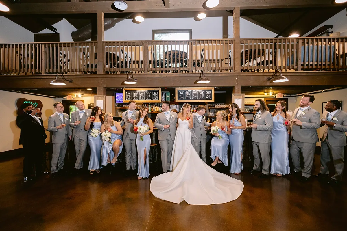 Wedding Party Reception at Barn at Bay Horse Inn | Weddings by Bretta Indianapolis Wedding Planner Bride, groom, and full wedding party celebrating inside the Barn at Bay Horse Inn reception hall, coordinated by Weddings by Bretta Indianapolis wedding coordinator