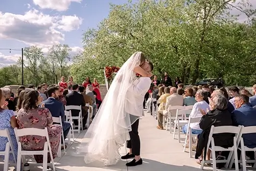 Hawthorns Golf Country Club Wedding Ceremony - First Kiss Fishers Indiana Hawthorns Golf Country Club outdoor wedding ceremony Fishers Indiana - groom lifting bride at first kiss