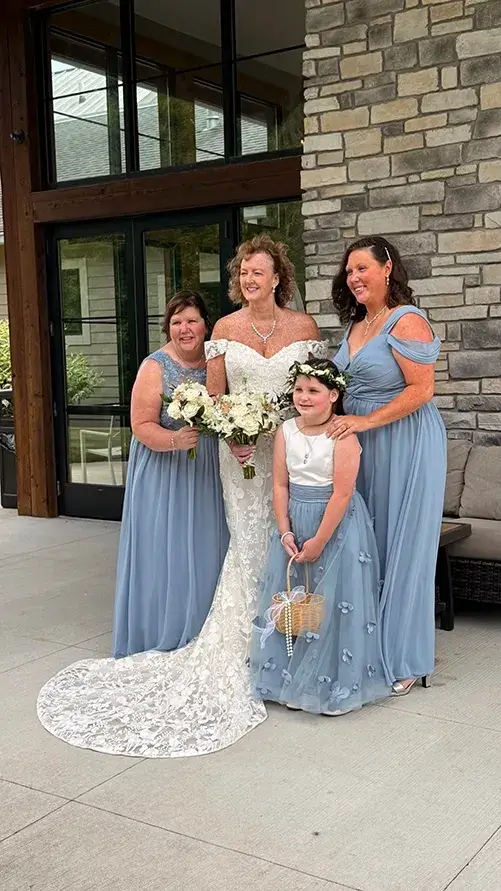 Greg & Shelly Wedding Party at The Sycamore at Mallow Run Bride Shelly posing with bridesmaids and flower girl outside The Sycamore at Mallow Run wedding venue in Indiana