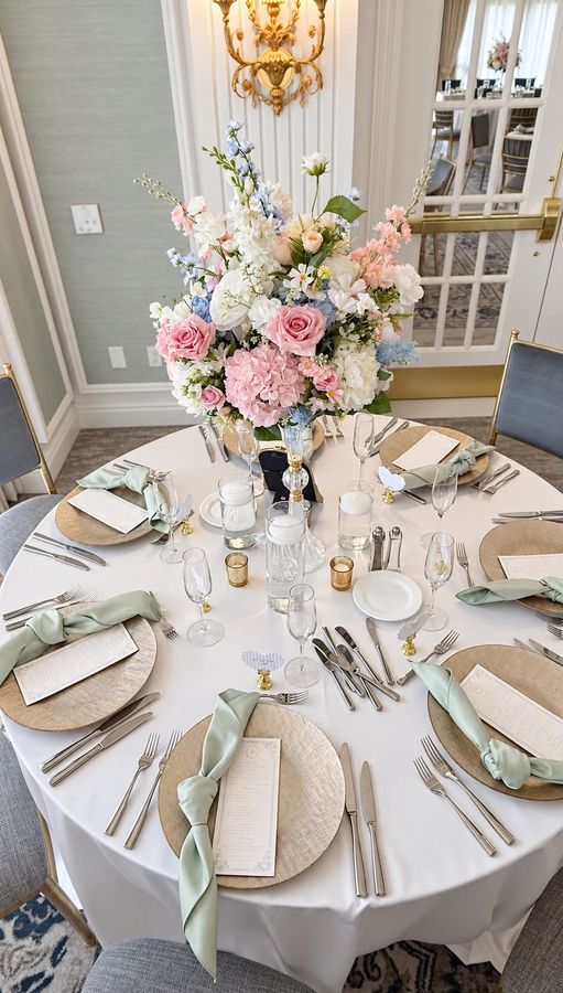 Wedding reception table with blush and blue florals at Hotel Carmichael in Carmel, Indiana