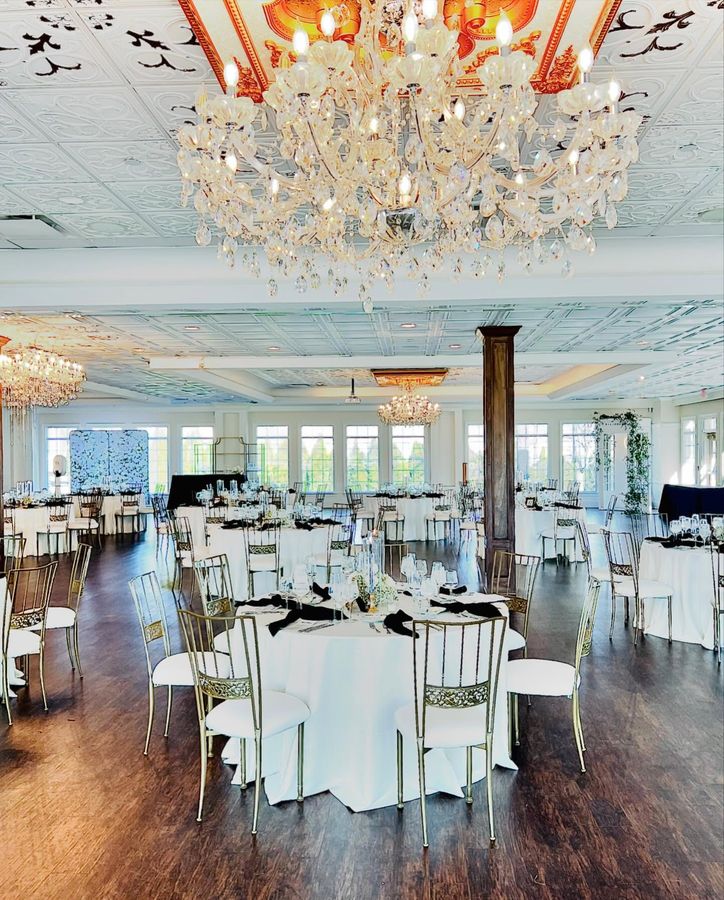 White ballroom wedding reception with crystal chandeliers in Indianapolis