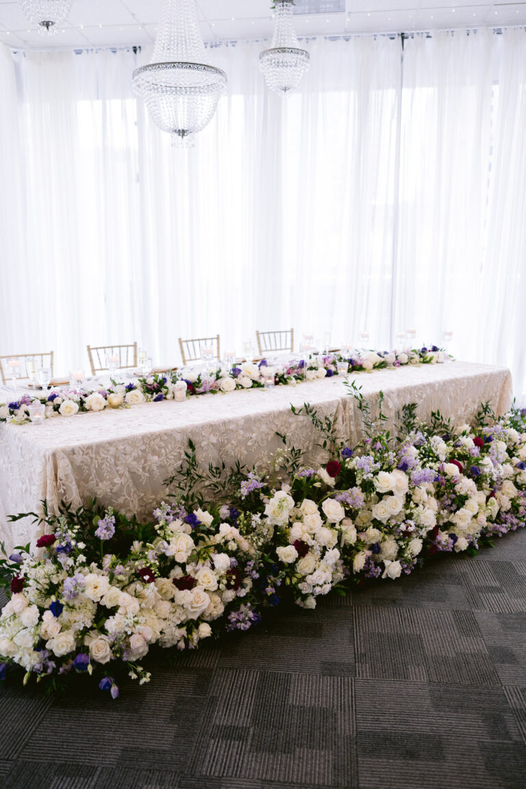 Head table florals at a wedding planned by an Indianapolis wedding planner