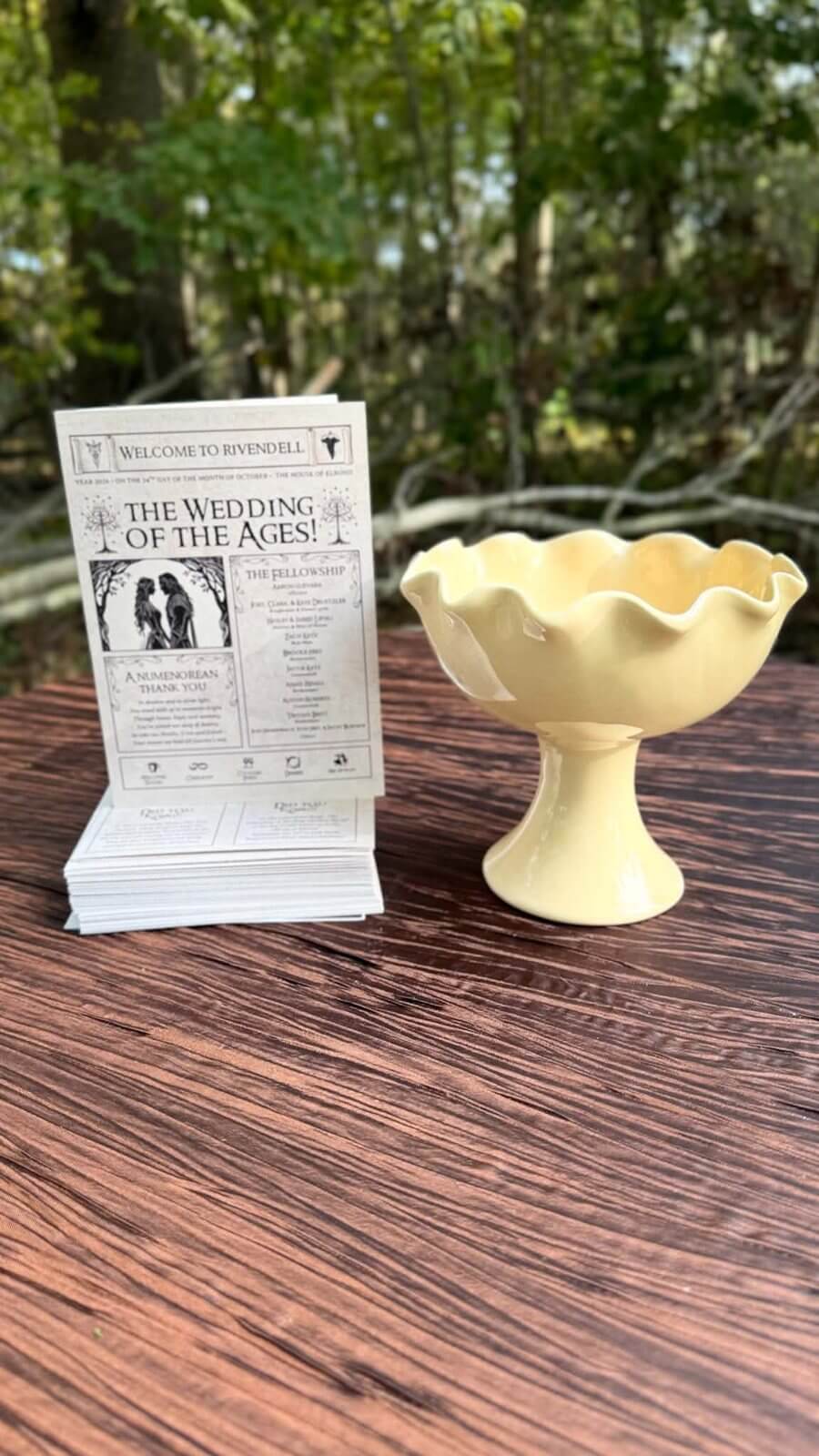 Wedding programs and wishing bowl on a table at The Sixpence