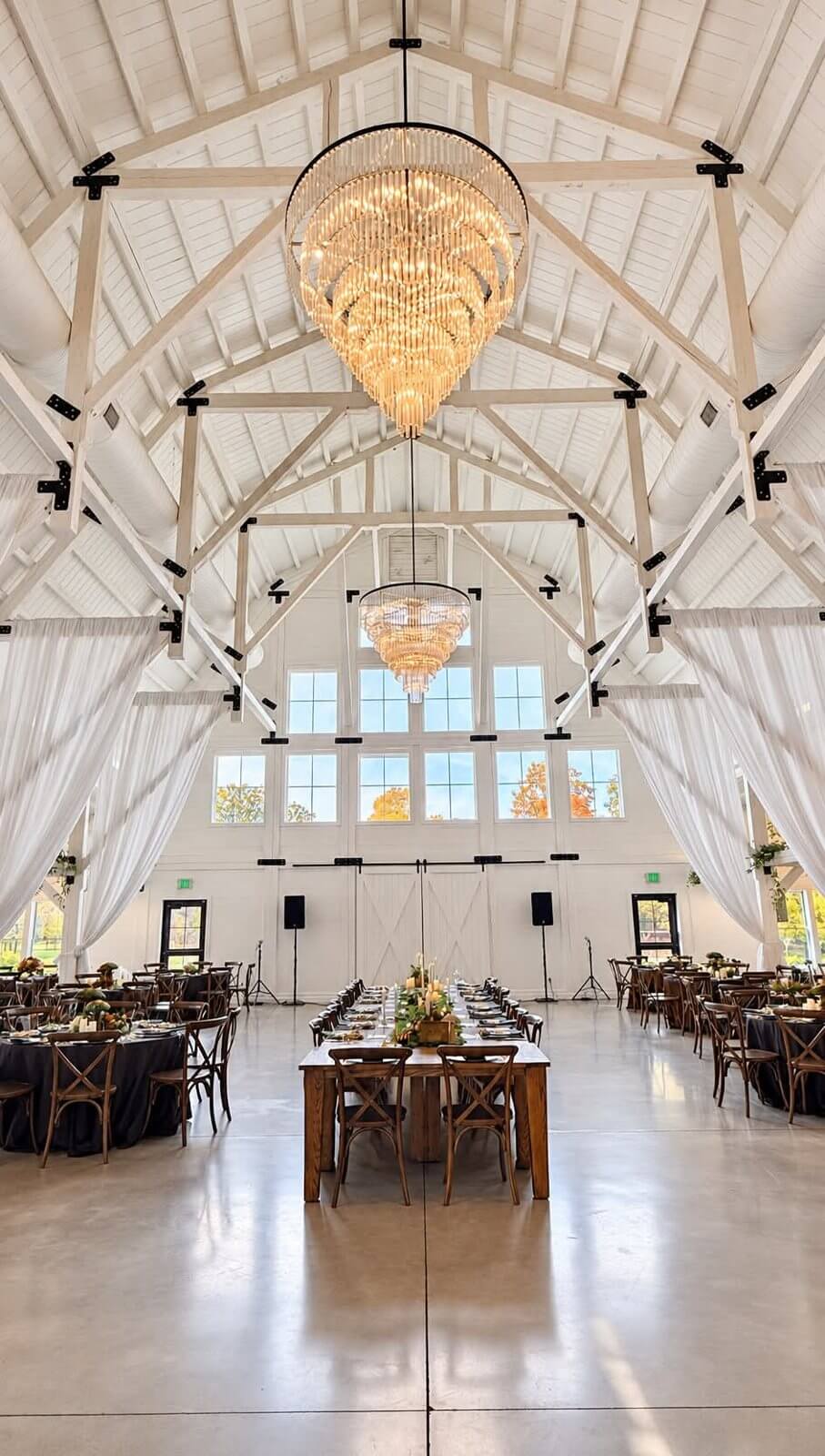 Barn reception with crystal chandeliers at The Sixpence in Whitestown, Indiana