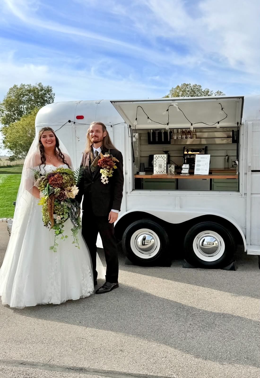 Bride and groom in front of a vintage coffee trailer at The Sixpence in Whitestown, Indiana