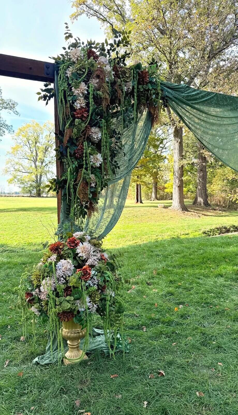 Floral ceremony arch with green draping at The Sixpence