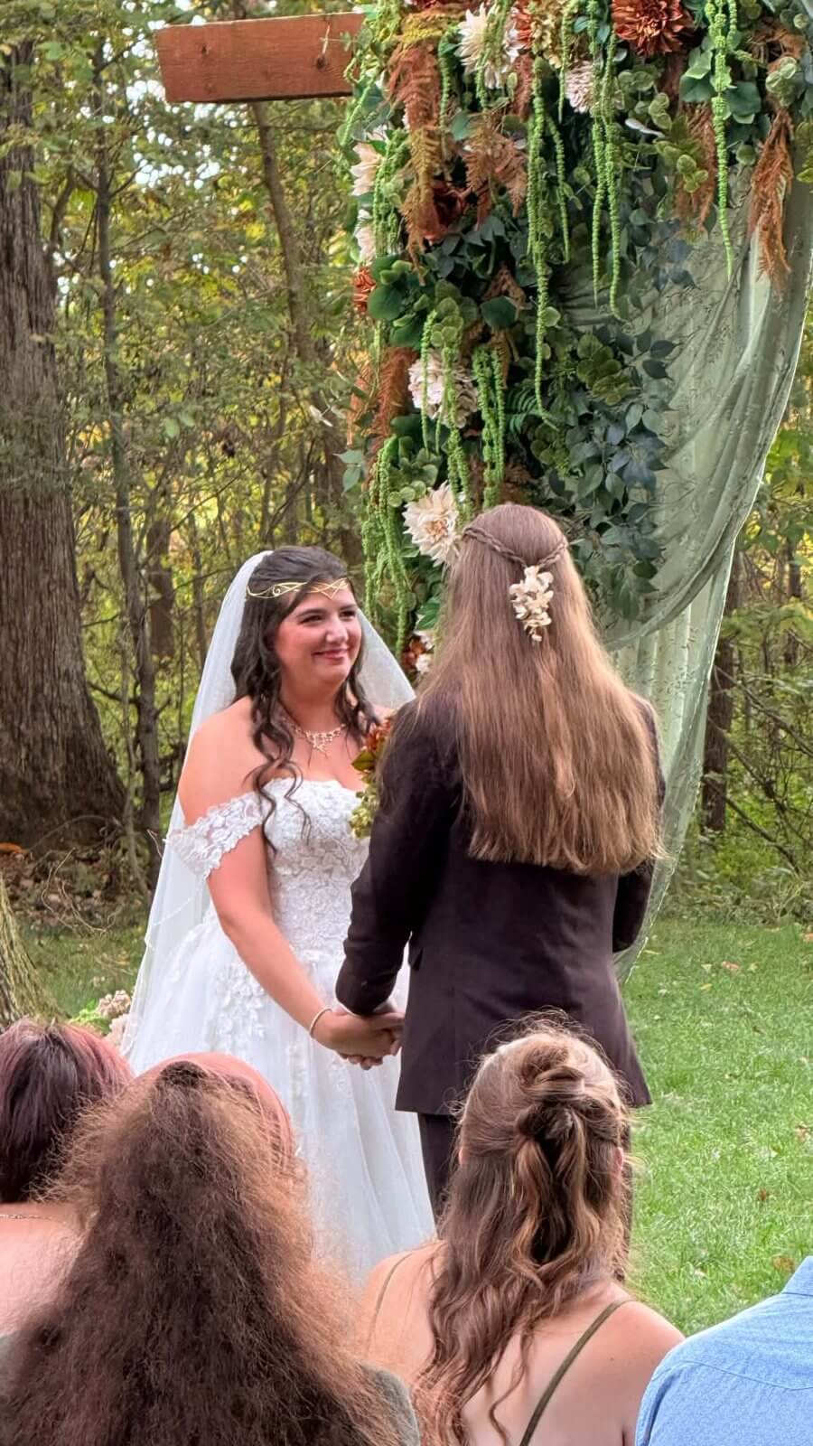 Couple exchanging vows at the wooded ceremony site at The Sixpence