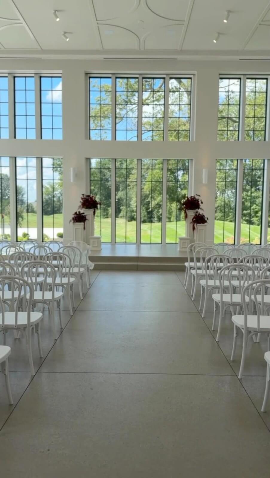 Ceremony aisle and white chairs in the Vowery at Westwood