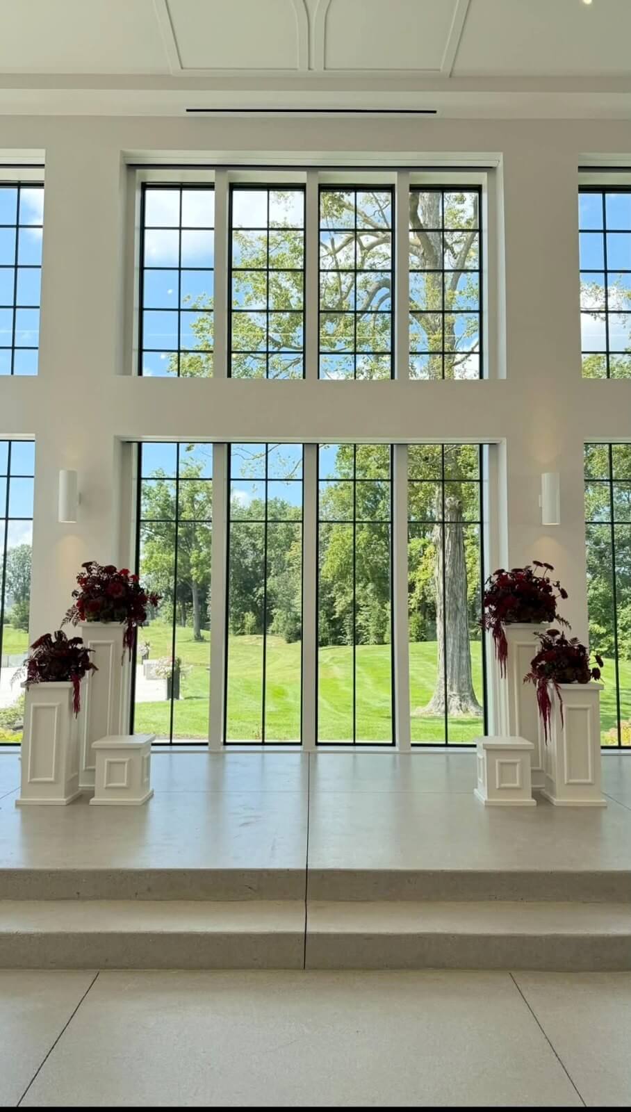 Ceremony altar with florals in front of the Vowery windows at Westwood
