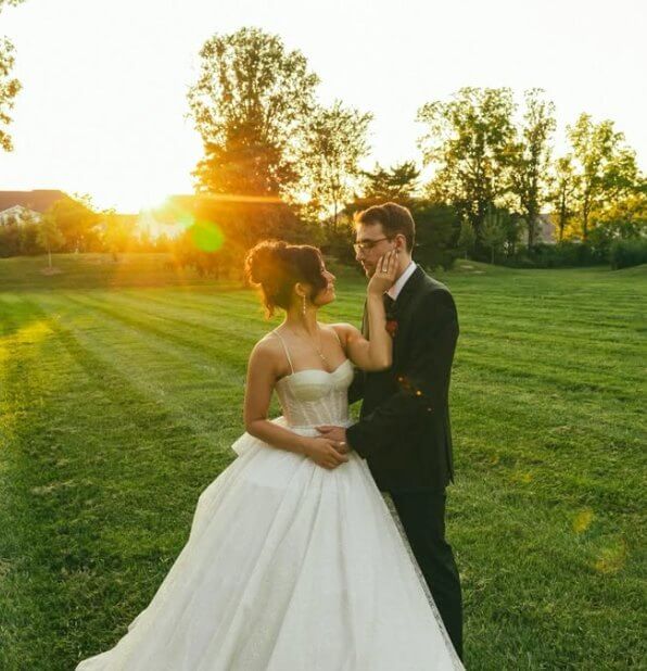 Bride and groom at sunset on the lawn at Westwood Vowery and Estate